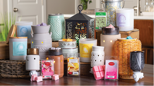 Assorted Candle Warmers Etc. wax warmers, candles and wax melts arranged on a wood table