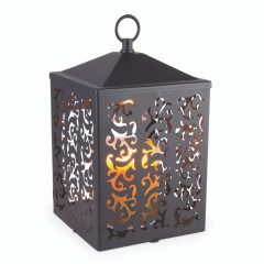 The Cottage Lantern features a scroll-like pattern that casts an ornate glow when lit. The matte metal design comes in a slightly textured, simple black finish.
