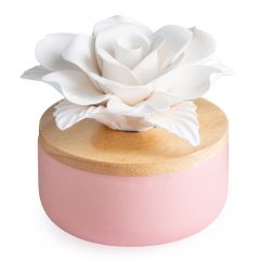The Rose Porcelain Diffuser features elegant porcelain rose petals that absorb and diffuse essential oils. A natural wooden lid is contrasted by a blush rose pink base, bringing an air of romance to any space.