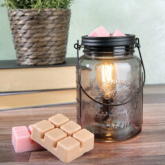 An elevated, repurposed feel is applied to the traditional mason jar with clear glass and a matte black warming dish and handle, all beautifully highlighted in the glow of the Vintage-style warming bulb. Includes two 2.5 oz Classic Wax Fragrance Melts - Cinnamon Roll and Watermelon Sugar Lemonade