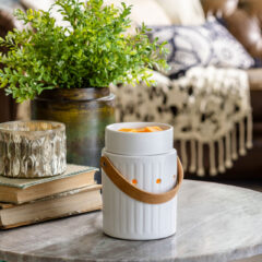 The Leather Handle Illumination Fragrance Warmer is a simple design that is both modern and classic. This fragrance warmer is crafted from the finest materials, and is the safest way to enjoy fragrance at home. A vertical design element gives the warmer a classic feel, while the white glaze showcases antique charm.