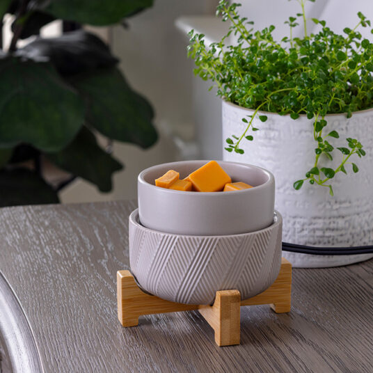 DESIGN: Enjoy the simple yet stunning functionality of the Wooden Pedestal 2-in-1 Fragrance Warmer with a low-key design. The curved wooden stand and grey ceramic finish will transform your living space into a relaxing oasis with the aroma of your favorite candles or wax melts.
FEATURES: Removable dish for use with your favorite fragrance wax melts, bricks or tarts. Easy on/off dial on cord and an indicator light so you know when it is on.
USE: For use with candles that are 10 oz or smaller or wax fragrance melts or wax tarts.
SPECS: Warming plate is 3.9