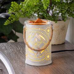 Rustic and chic, enjoy your choice of wax melts in our Lone Star Illumination Fragrance Warmer and watch as soft patterns of light dance across the walls. 
This warmer gives off a vintage feel with a braided rope handle and tin canister vessel, serving as a star-of-the-show statement piece or as a versatile addition to any room's decor.
USE: Add scented wax melts to the removable warming dish to safely release fragrance throughout your home. Recommended with our Artisan or Aromatherapy soy wax melts or Classic or Odor Eliminating soy blend wax melts.
FUNCTION: Decorative electric fragrance warmer designed to warm scented wax and create the ambient glow of a burning candle. Includes NP3 Vintage Bulb.
FUNCTION: No flame reduces the risk of house fires, while also eliminating carbon toxins, smoke and soot from the air.
INCLUDES: Warmer and NP3 Vintage Warming bulb. Cord is 3 ft long with dial switch for easy on/off. 1 Year limited warranty against factory defects.
Illumination Fragrance Warmers are our top-selling traditional warmers. Each is designed with your style in mind to accent your home decor, whether it is traditional, transitional, farmhouse, modern, cottage, Scandinavian, or more! We use high-quality ceramic, porcelain, metals and glass to provide a product worthy of the included one-year warranty.
Vintage Illumination Fragrance Warmers feature vintage style bulbs paired with a variety of materials and styles that allow the warm glow of the vintage bulb to be the focal point.