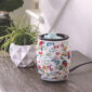 DESIGN: Let your spirit bloom with the vibrant floral beauty of the Flip Dish Wax Warmer. This lively table-top wax warmer brings a burst of artsy, whimsical charm to any space. With its beautiful wild blooms motif against a crisp white background, this wax warmer is not only eye-catching but is also easy to use, as the flip dish allows for easy removal of wax melts.
USE: The silicone dish sits on a metal warming plate. The dish allows for simple, easy removal of cooled fragrance wax by simply popping it out! The 3 ft cord features an easy on/off dial switch.
EASY HOME FRAGRANCE: Forget changing bulbs or struggling to get your wax out of ceramic dishes. This warmer never needs a bulb change. It heats the wax using a warming plate! The silicone dish cools quickly for safer handling. Once wax is completely cooled, it can be popped out of the silicone with ease!
PERFECTLY SIZED: The warmer is 5