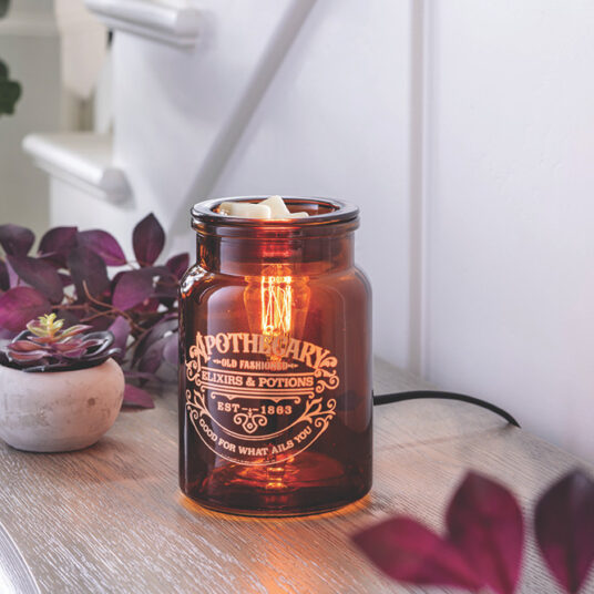 The Apothecary Illumination Fragrance warmer will allure you with amber-colored glass and an Edison style bulb from within. The enchanting dark academia glow that fills the room will set the vibe for a relaxing night at home while bringing any style of decor to life. Melt your favorite home fragrance in the dish on top of the vessel, which resembles an old fashioned medicine jar.