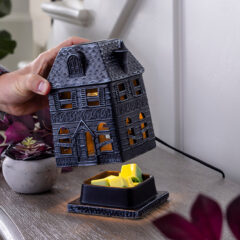 Calling all Halloween lovers, it's time to get spooky. This Haunted Mansion Canopy Fragrance Warmer will become a staple of your home's seasonal decorating for years to come. Made of porcelain with an eerie touch, the boarded-up windows cast soft light and the allure of mystery within the walls. Enchant your home with your favorite autumn scents and set the mood with ghostly lighting as wax melts are warmed and illuminated from within.