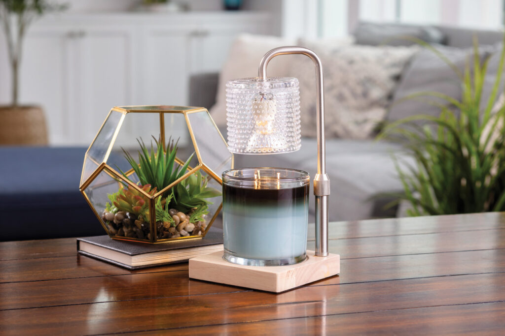 Add a touch of elegance to your home with our Silver Hobnail Glass Candle Warmer Lamp. The clear glass shade allows light and warmth to shine through freely, while the glass flutes create a beautiful decorative effect. Our candle warmer lamps use top-down warming technology that lets you enjoy the scent and ambiance of a candle without a flame. Features an adustable stem and timer/dimmer switch.