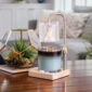 Add a touch of elegance to your home with our Silver Hobnail Glass Candle Warmer Lamp. The clear glass shade allows light and warmth to shine through freely, while the glass flutes create a beautiful decorative effect. Our candle warmer lamps use top-down warming technology that lets you enjoy the scent and ambiance of a candle without a flame. Features an adustable stem and timer/dimmer switch.