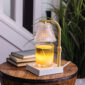 Add a touch of elegance to your home with our Gold Luna Candle Warmer Lamp. The clear glass shade allows light and warmth to shine through freely, while the glass flutes create a beautiful decorative effect. Our candle warmer lamps use top-down warming technology that lets you enjoy the scent and ambiance of a candle without a flame. Features an adustable stem and timer/dimmer switch.