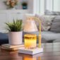 Add a touch of elegance to your home with our Gold Luna Candle Warmer Lamp. The clear glass shade allows light and warmth to shine through freely, while the glass flutes create a beautiful decorative effect. Our candle warmer lamps use top-down warming technology that lets you enjoy the scent and ambiance of a candle without a flame. Features an adustable stem and timer/dimmer switch.