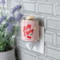 Sweeten your space with a touch of nostalgia with the Lucky Cherry Pluggable Fragrance Warmer, a delightful blend of vintage charm and modern functionality. Reminiscent of old-fashioned soda shops, the Lucky Cherry Pluggable Fragrance Warmer features a beautifully detailed pink soda bottle design. The vibrant red 