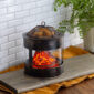 The Fire Pit Wax Warmer brings the cozy ambiance of a crackling fire into your home. The design mimics a rustic fire pit, featuring a mesh lid and the comforting glow of smoldering embers. Enjoy the essence of the outdoors year-round while filling your space with your favorite scents.