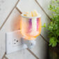 Elevate your aesthetic with the Iridescent Glow Pluggable Warmer. Its vibrant, iridescent finish and raindrop design create a soft, colorful glow while gently warming your favorite fragrances. The compact, plug-in design is perfect for small spaces, adding both style and soothing scents to any room.