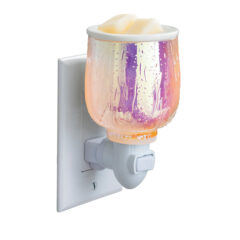 Elevate your aesthetic with the Iridescent Glow Pluggable Warmer. Its vibrant, iridescent finish and raindrop design create a soft, colorful glow while gently warming your favorite fragrances. The compact, plug-in design is perfect for small spaces, adding both style and soothing scents to any room.
