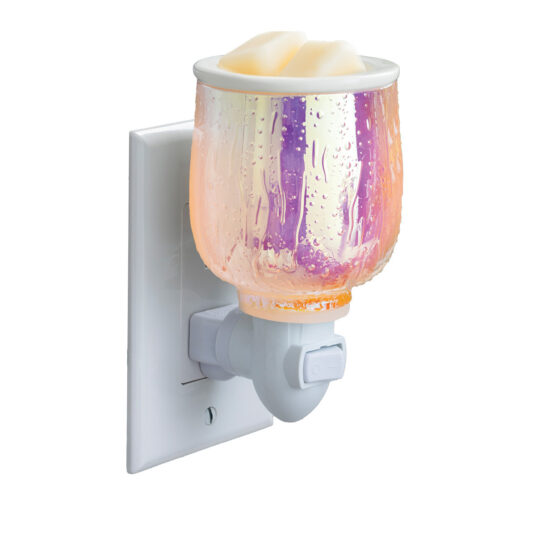Elevate your aesthetic with the Iridescent Glow Pluggable Warmer. Its vibrant, iridescent finish and raindrop design create a soft, colorful glow while gently warming your favorite fragrances. The compact, plug-in design is perfect for small spaces, adding both style and soothing scents to any room.