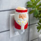 The St. Nick Pluggable Fragrance Warmer channels festive joy. This cheerful warmer features jolly old St. Nick, clad in his classic red outfit and snowy white beard. Perfect for adding a soft glow to small spaces, simply plug in to any outlet to gently warm your favorite holiday scents. Add Santa’s charm, warmth, and merriment to your home!