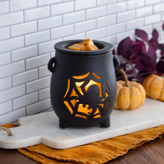 The Creepy Cauldron Fragrance Warmer brings a spooky-charming touch to your Halloween décor. The textured black cauldron features a spider and web cutout design that sets an eerie mood while melting your favorite scents. Perfect for filling your home with festive, ghoulish fragrance all season long.