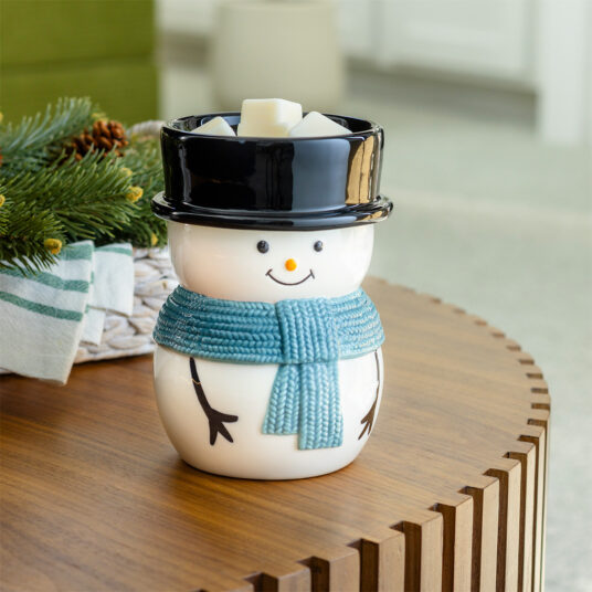 Bring the magic of winter into your home with our Snowy Illumination Fragrance Warmer. This charming warmer features an adorable snowman, complete with a classic black top hat and a cheerful blue scarf. When turned on, it emits a warm, inviting glow that enhances the festive ambiance of any space.