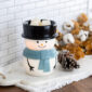 Bring the magic of winter into your home with our Snowy Illumination Fragrance Warmer. This charming warmer features an adorable snowman, complete with a classic black top hat and a cheerful blue scarf. When turned on, it emits a warm, inviting glow that enhances the festive ambiance of any space.