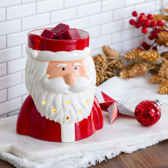 Welcome the holiday spirit with our St. Nick Fragrance Warmer, featuring a jolly Santa in his classic red suit and fluffy white beard. This cheerful warmer emits a warm, cozy glow when lit, adding festive charm to your décor—perfect for holiday gatherings or relaxing evenings by the fire.
