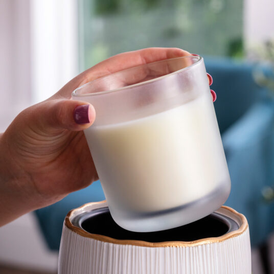 Elevate your home with the Golden Ridges Crock Candle Warmer, featuring an ivory stoneware body accented by a refined gold ridged rim for timeless style.