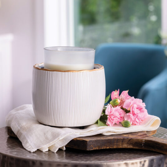 Elevate your home with the Golden Ridges Crock Candle Warmer, featuring an ivory stoneware body accented by a refined gold ridged rim for timeless style.