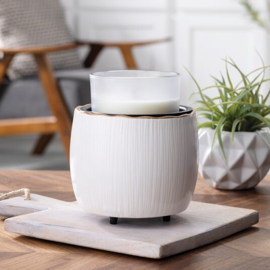 Elevate your home with the Golden Ridges Crock Candle Warmer, featuring an ivory stoneware body accented by a refined gold ridged rim for timeless style.