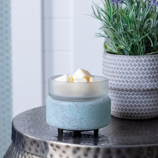 Bring coastal elegance to your space with the Beach Glass 2-in-1 Warmer, showcasing a flecked aqua sea glass base and a removable frosted dish for easy cleaning.