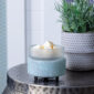 Bring coastal elegance to your space with the Beach Glass 2-in-1 Warmer, showcasing a flecked aqua sea glass base and a removable frosted dish for easy cleaning.