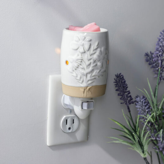 Garden Blooms Pluggable Warmer features delicate embossed floral patterns in a soft neutral palette to bring botanical charm while warming wax melts safely.