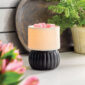 The Luxe Lamp Illumination Warmer features a chic contrast of matte black and textured white ceramic. This warmer makes a bold, stylish statement while effortlessly filling your space with fragrance.