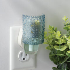 The Hobnail WallScents™ Warmer features a vintage-inspired textured translucent surface in soft blue, casting a cozy glow while gently warming oil for long-lasting fragrance