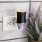 The Hourglass WallScents™ Warmer features a sleek black silhouette with gold accents, adding a touch of luxury to any room.