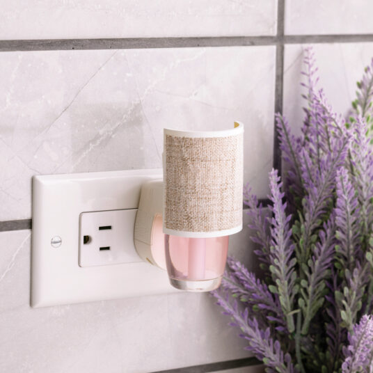 Wrapped in soft, natural woven fabric, the Linen WallScents Warmer adds effortless warmth and texture to any room.