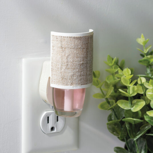 Wrapped in soft, natural woven fabric, the Linen WallScents Warmer adds effortless warmth and texture to any room.