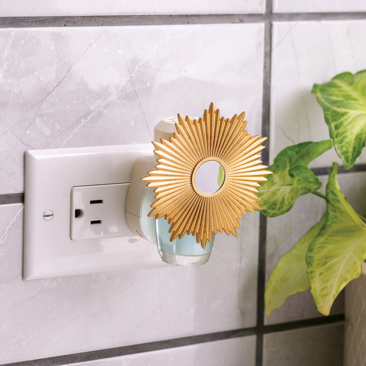 Brighten your space with the Sunburst WallScents™ Fragrance Warmer. Its golden sunburst and mirrored center make a bold statement while gently warming oil for a clean, consistent fragrance—no flame, no mess.