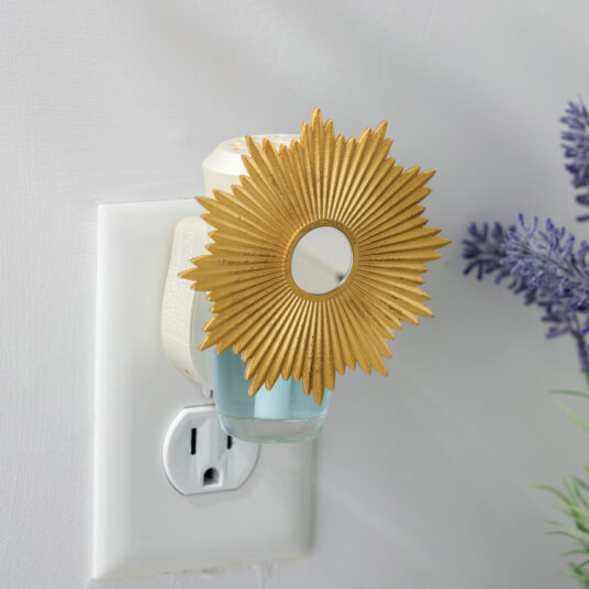 Brighten your space with the Sunburst WallScents™ Fragrance Warmer. Its golden sunburst and mirrored center make a bold statement while gently warming oil for a clean, consistent fragrance—no flame, no mess.
