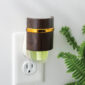 With its rich wood-look finish and sleek metallic accents, the Walnut WallScents™ Warmer adds a touch of modern sophistication to any room.