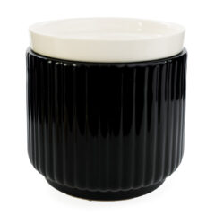 Glossy black ribbed ceramic meets a crisp white removable dish in the Noir Wax Warmer for a striking, modern silhouette that elevates contemporary decor.