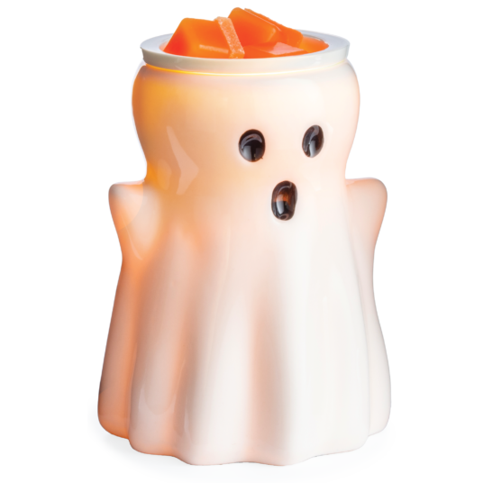 White ceramic ghost-shaped wax warmer holding orange melted wax