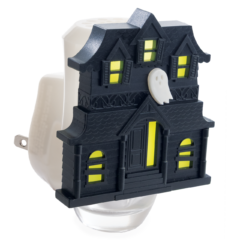 Black haunted mansion-shaped plug-in wax warmer night light with glowing windows