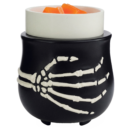 Black skeleton-hand design wax warmer holding orange melted wax