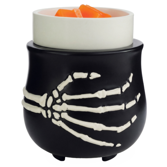 Black skeleton-hand design wax warmer holding orange melted wax